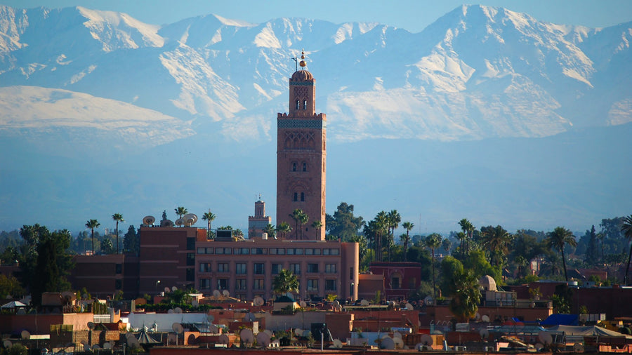 The Koutoubia minaret above Marrakech with the snow-capped Atlas behind, the city where Saïd Lahssini lives and works