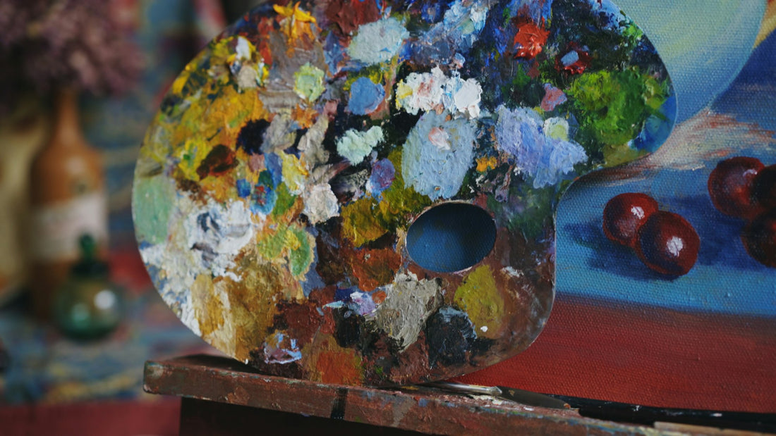 Artist's palette with colourful blobs of paint in a painting studio